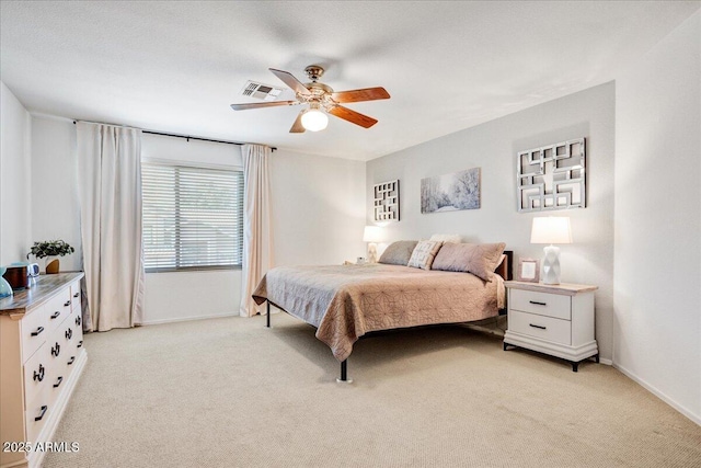 bedroom with light carpet, baseboards, visible vents, and a ceiling fan