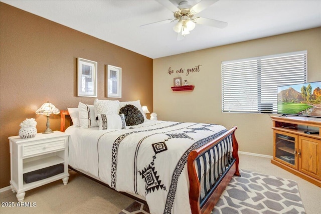 bedroom with baseboards, a ceiling fan, and light colored carpet