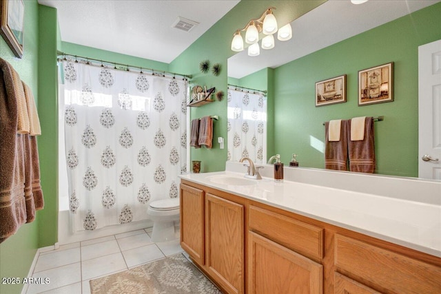 bathroom with tile patterned flooring, visible vents, vanity, and toilet