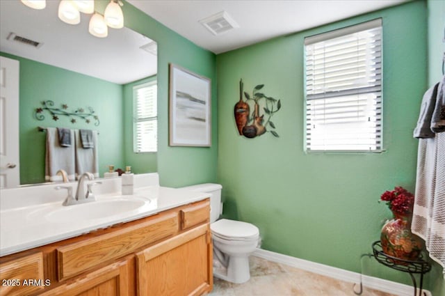 bathroom with toilet, baseboards, visible vents, and vanity