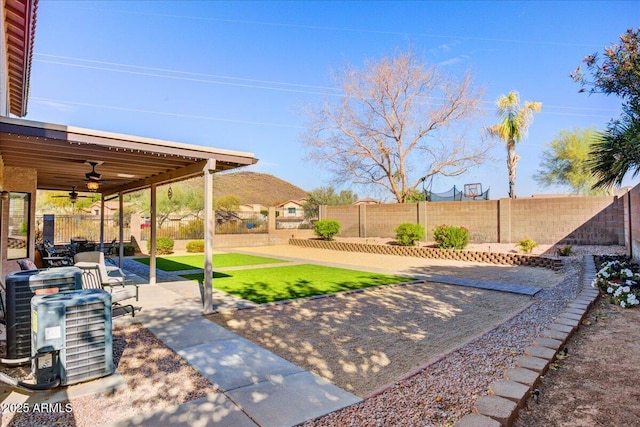 view of yard with ceiling fan, a patio, and a fenced backyard