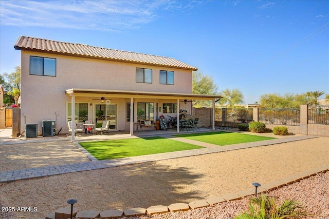 back of house featuring a ceiling fan, fence, central air condition unit, a patio area, and stucco siding