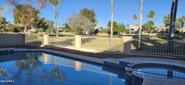 view of pool with an in ground hot tub