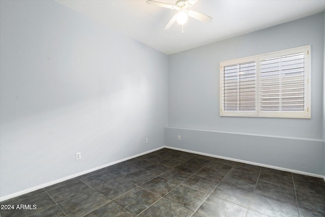 tiled spare room with ceiling fan