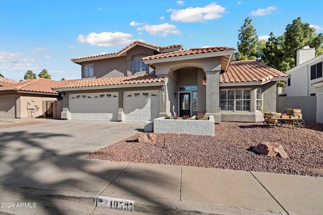 mediterranean / spanish-style home with a garage