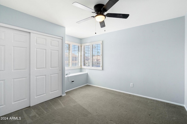 unfurnished bedroom featuring carpet flooring, ceiling fan, and a closet