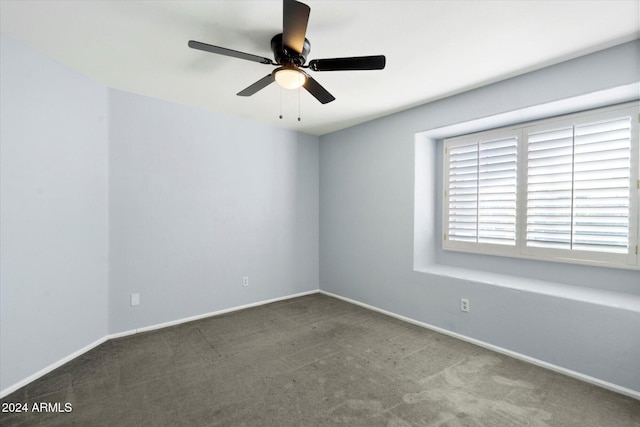 empty room with ceiling fan and carpet