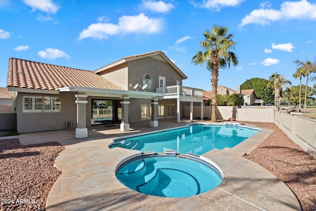 view of pool with a patio area and an in ground hot tub