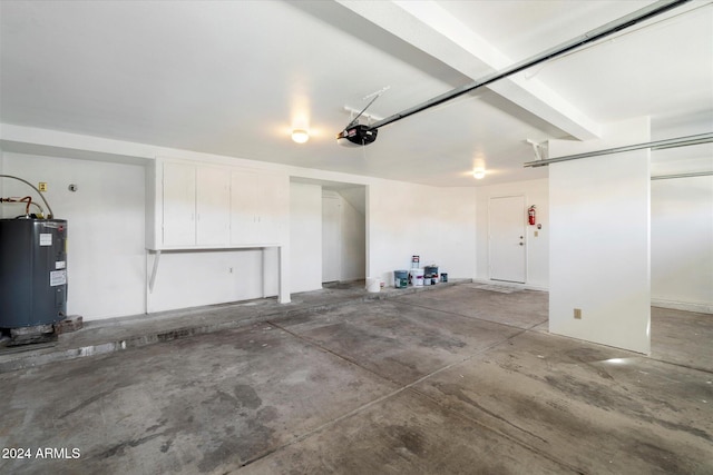 garage with electric water heater and a garage door opener