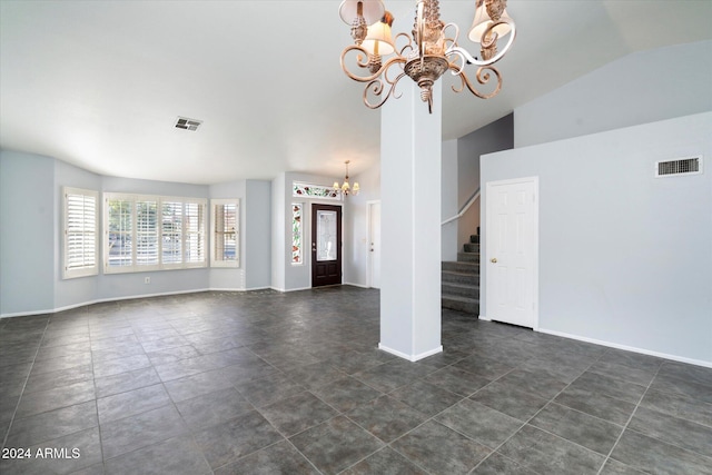 unfurnished living room with vaulted ceiling, an inviting chandelier, and dark tile patterned floors