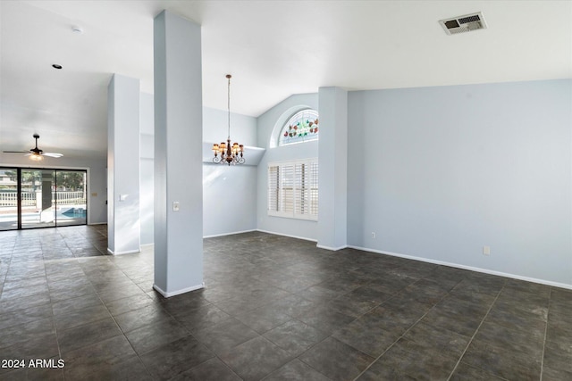 spare room with ceiling fan with notable chandelier and vaulted ceiling