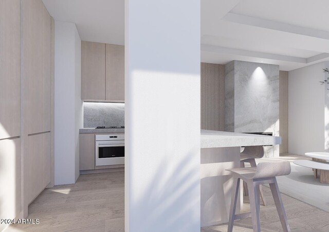 kitchen with light brown cabinets and a breakfast bar area