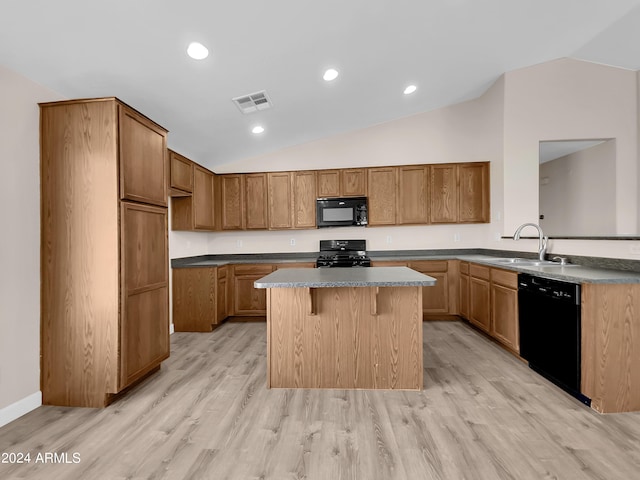 kitchen featuring sink, a kitchen island, black appliances, and lofted ceiling