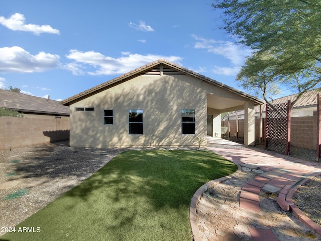 back of house with a lawn