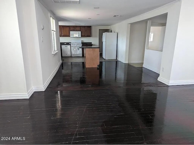 kitchen with a kitchen island, stainless steel appliances, and dark hardwood / wood-style floors