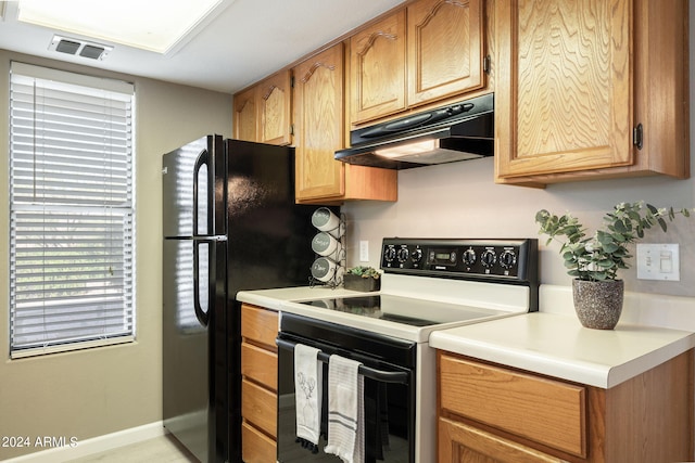 kitchen with black refrigerator and white electric stove