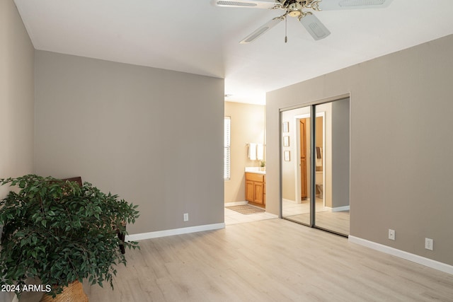 spare room featuring light wood-type flooring and ceiling fan