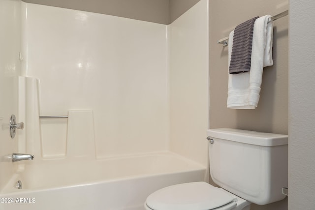 bathroom featuring shower / washtub combination and toilet