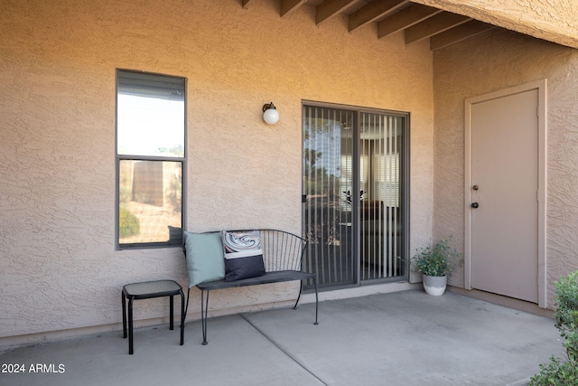 view of exterior entry featuring a patio area