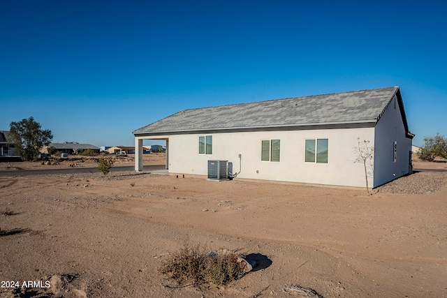 rear view of property featuring central AC