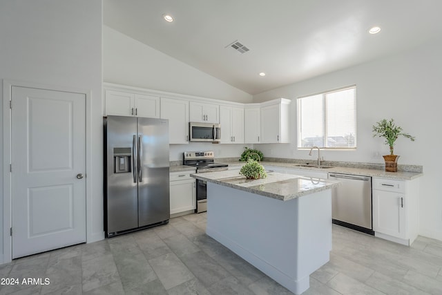 kitchen with white cabinetry, sink, lofted ceiling, and stainless steel appliances