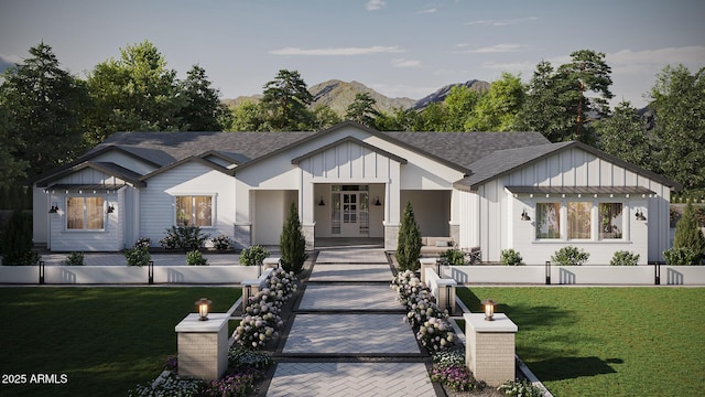 modern inspired farmhouse with a front lawn, a mountain view, board and batten siding, and roof with shingles