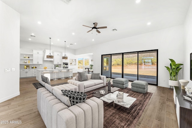 13930 E Barwick Dr, Scottsdale, AZ 85262 - living area featuring light wood-type flooring, visible vents, recessed lighting, and a ceiling fan