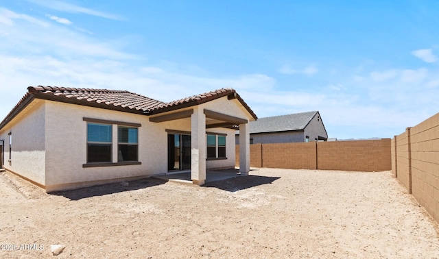 3913 S 233rd Ln, Buckeye, AZ 85326 - rear view of house with a fenced backyard, stucco siding, a patio, and a tile roof