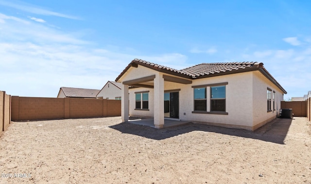 3913 S 233rd Ln, Buckeye, AZ 85326 - back of property with a fenced backyard, stucco siding, a tile roof, a patio, and central AC unit