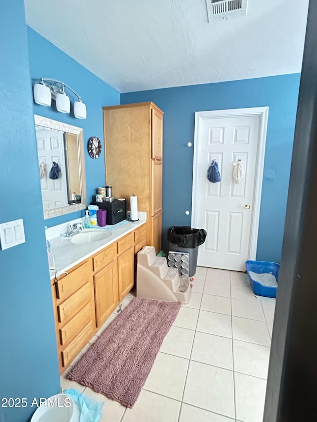 bathroom featuring tile patterned flooring, visible vents, and vanity