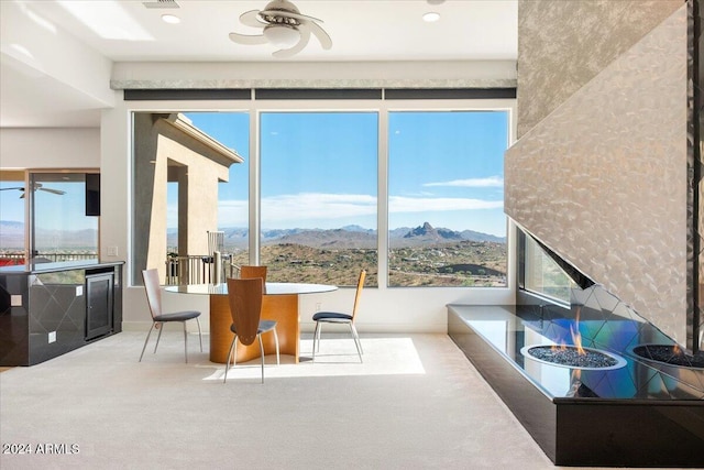 interior space with a mountain view, ceiling fan, and wine cooler