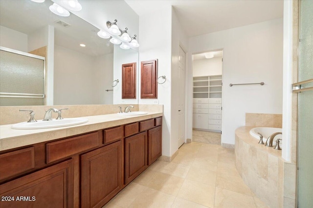 bathroom featuring tile patterned floors, plus walk in shower, and vanity