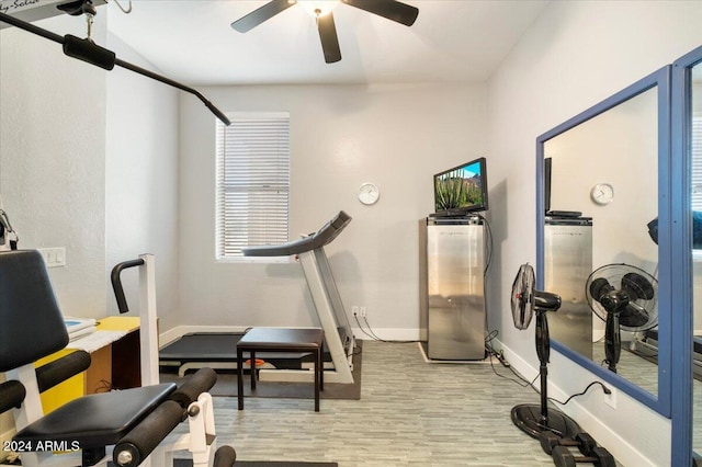 workout area featuring ceiling fan and light hardwood / wood-style flooring