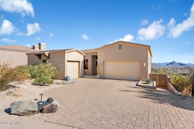 view of front of property featuring a mountain view and a garage