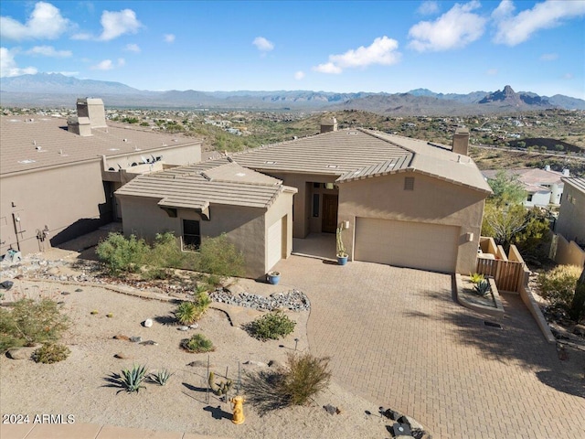 view of front of home featuring a mountain view and a garage