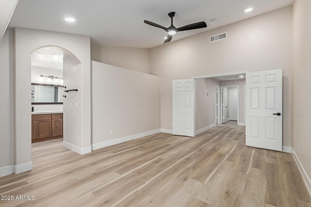 2189 E Ranch Ct, Gilbert, AZ 85296 - spare room with ceiling fan, light wood-style flooring, high vaulted ceiling, arched walkways, and baseboards
