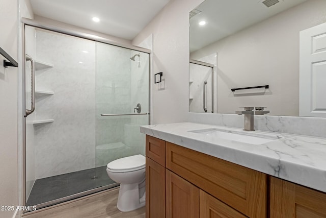 2189 E Ranch Ct, Gilbert, AZ 85296 - bathroom with toilet, vanity, wood finished floors, a shower stall, and recessed lighting