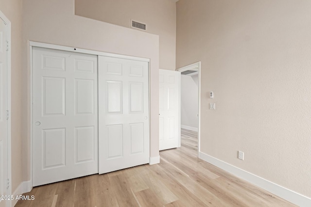 2189 E Ranch Ct, Gilbert, AZ 85296 - unfurnished bedroom with baseboards, light wood-style flooring, and a closet