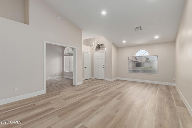 2189 E Ranch Ct, Gilbert, AZ 85296 - unfurnished living room with light wood-type flooring, lofted ceiling, baseboards, a chandelier, and recessed lighting