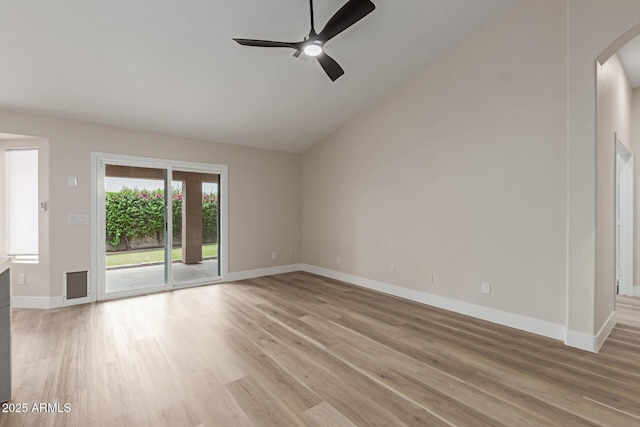 2189 E Ranch Ct, Gilbert, AZ 85296 - spare room featuring a ceiling fan, arched walkways, light wood-style flooring, vaulted ceiling, and baseboards