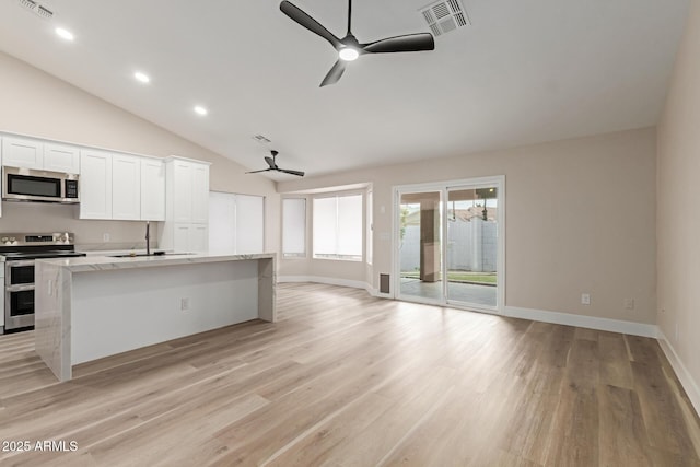 2189 E Ranch Ct, Gilbert, AZ 85296 - kitchen with appliances with stainless steel finishes, a ceiling fan, open floor plan, a center island with sink, and light wood-style floors