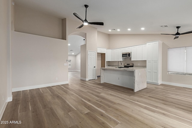 2189 E Ranch Ct, Gilbert, AZ 85296 - kitchen with a ceiling fan, stainless steel microwave, open floor plan, white cabinetry, and recessed lighting