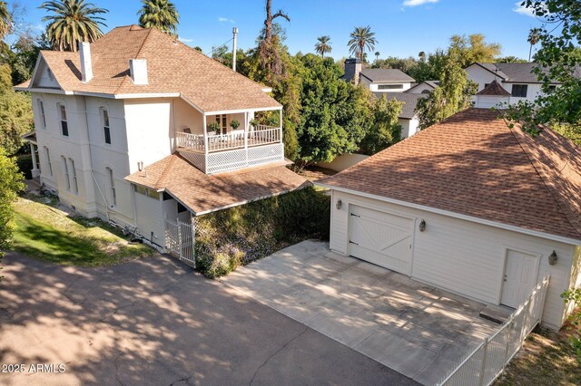7252 N Central Ave, Phoenix, AZ 85020 - view of property exterior featuring a balcony, roof with shingles, concrete driveway, and a chimney