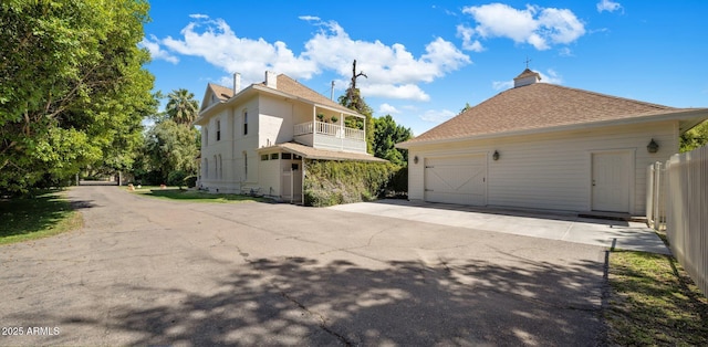 7252 N Central Ave, Phoenix, AZ 85020 - view of side of home with a balcony, a detached garage, and driveway