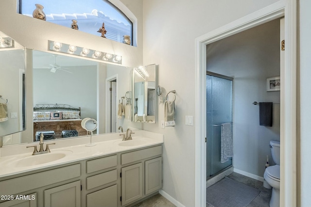 bathroom featuring vanity, ceiling fan, a shower with door, and toilet