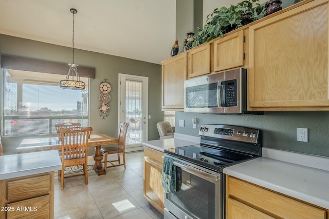 kitchen featuring light brown cabinetry, hanging light fixtures, light tile patterned floors, and appliances with stainless steel finishes