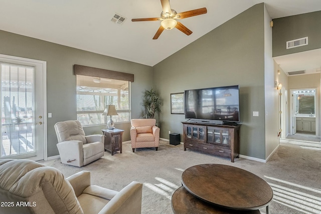 carpeted living room with high vaulted ceiling and ceiling fan