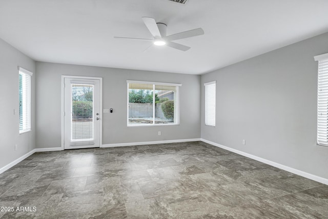 spare room featuring baseboards and ceiling fan