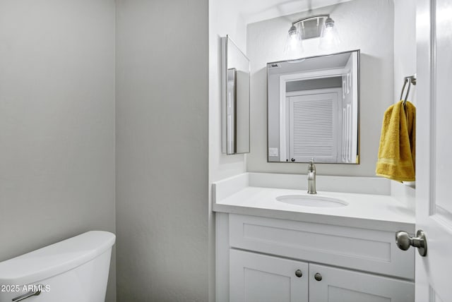 half bath featuring toilet and vanity