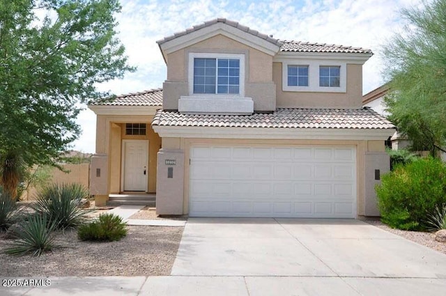 mediterranean / spanish house with stucco siding, concrete driveway, an attached garage, and a tiled roof